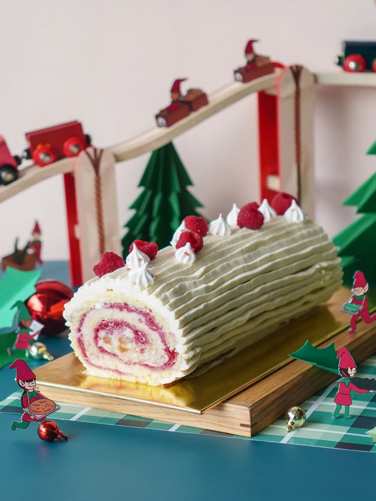 Festive Christmas raspberry yule log with meringue kisses