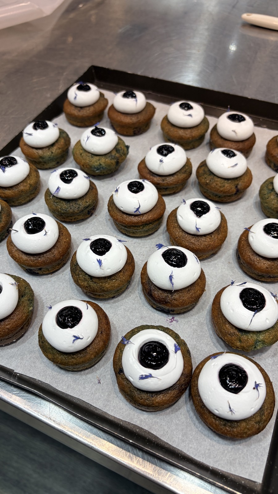 Blueberry financiers topped with cream and blueberry for a product demo